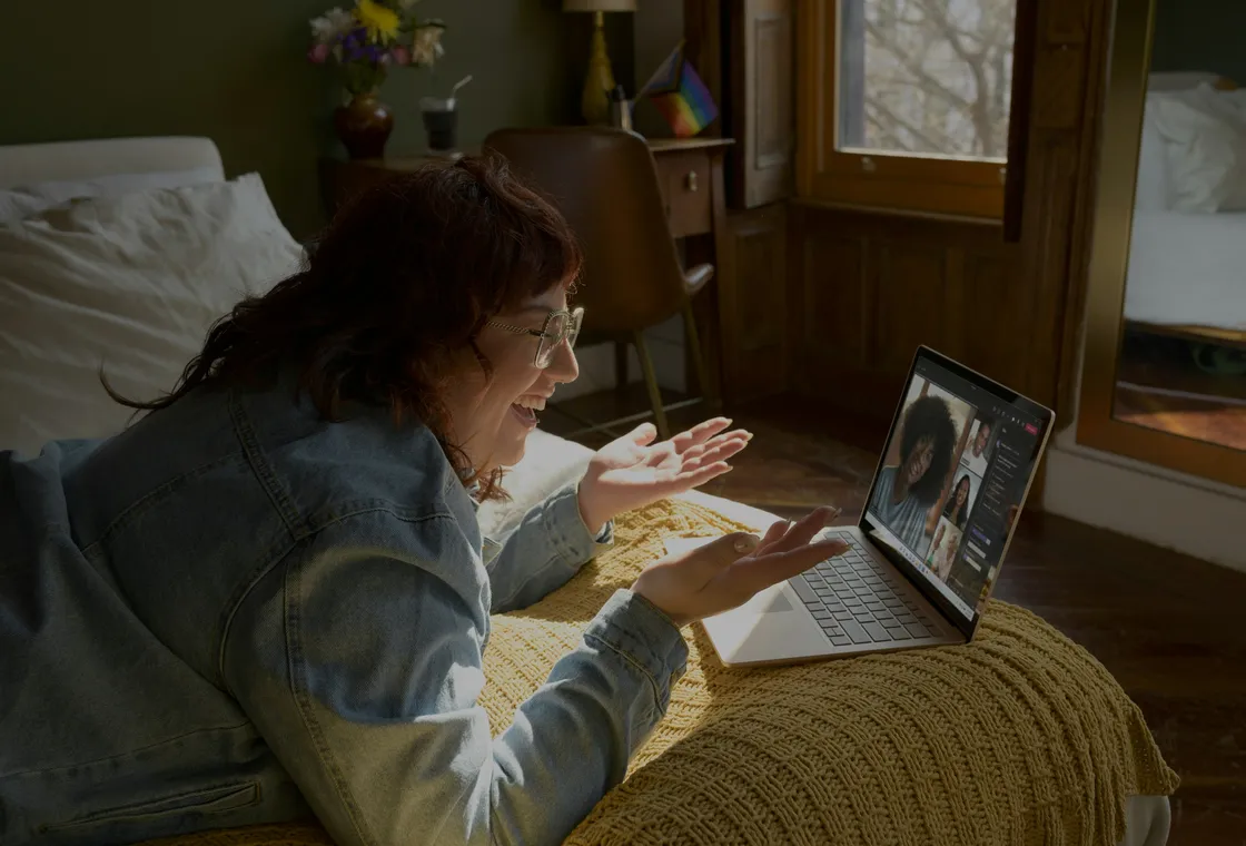 A woman at home mid-conversation with her therapist on a laptop screen